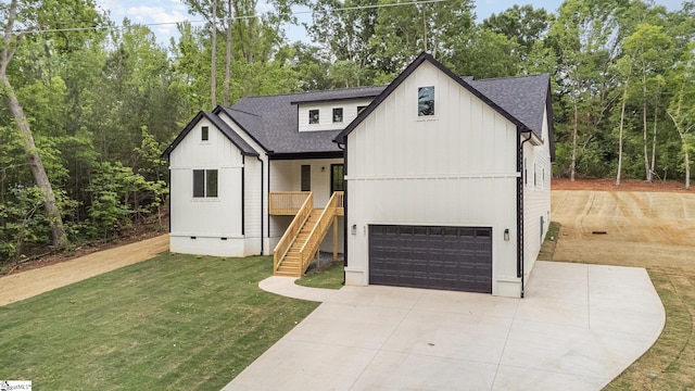modern farmhouse style home featuring stairway, a front yard, an attached garage, and roof with shingles