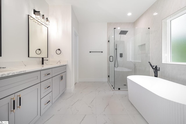 bathroom featuring a shower stall, marble finish floors, double vanity, a freestanding tub, and recessed lighting
