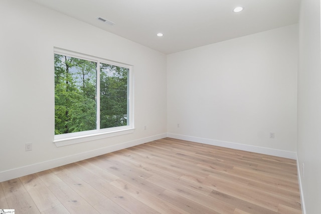 empty room featuring baseboards, recessed lighting, and light wood-style floors