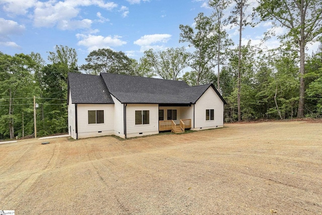 view of front of home featuring crawl space, roof with shingles, and a deck