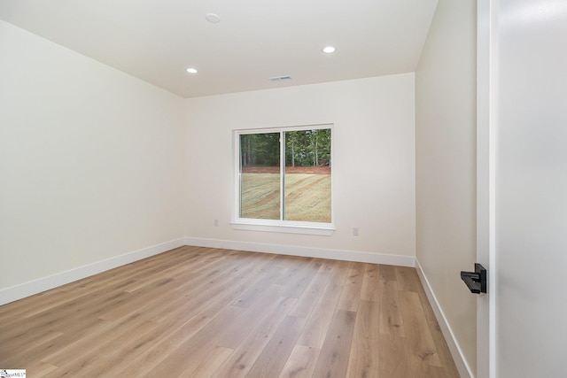 unfurnished room with baseboards, light wood-style floors, and recessed lighting