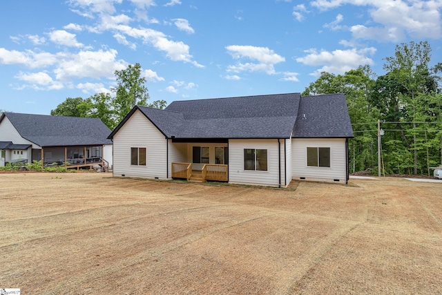 rear view of house with crawl space, a shingled roof, and a deck
