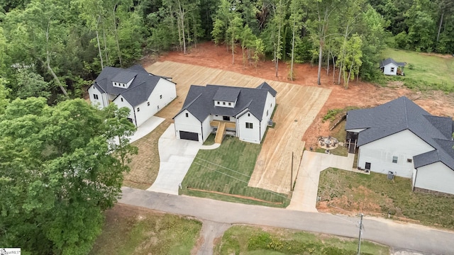aerial view of property and surrounding area featuring a forest