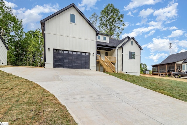 modern farmhouse featuring board and batten siding, a front lawn, driveway, and crawl space