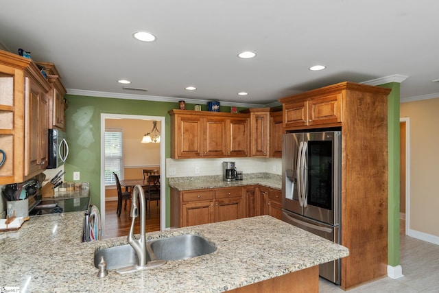 426 Isaqueena Dr, Greer, SC 29651 - kitchen with stainless steel appliances, a sink, ornamental molding, baseboards, and light stone countertops