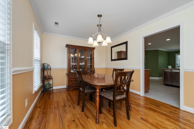 426 Isaqueena Dr, Greer, SC 29651 - dining room with a chandelier, plenty of natural light, light wood-style floors, baseboards, and crown molding