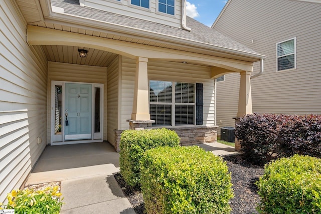 11 Penrith Ct, Simpsonville, SC 29681 - view of exterior entry featuring a shingled roof, a porch, central AC, and stone siding