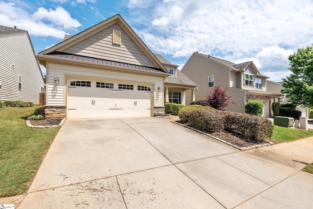 11 Penrith Ct, Simpsonville, SC 29681 - craftsman-style home with stone siding, driveway, a standing seam roof, a garage, and a front lawn