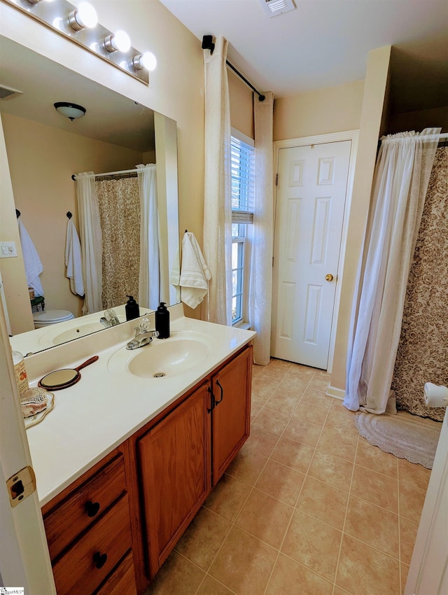 bathroom with tile patterned floors and vanity