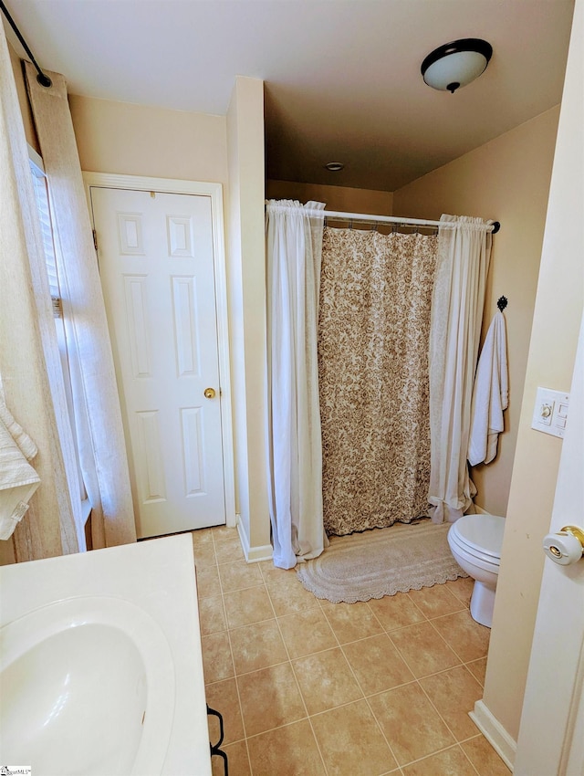 bathroom featuring tile patterned floors, toilet, and a shower with shower curtain