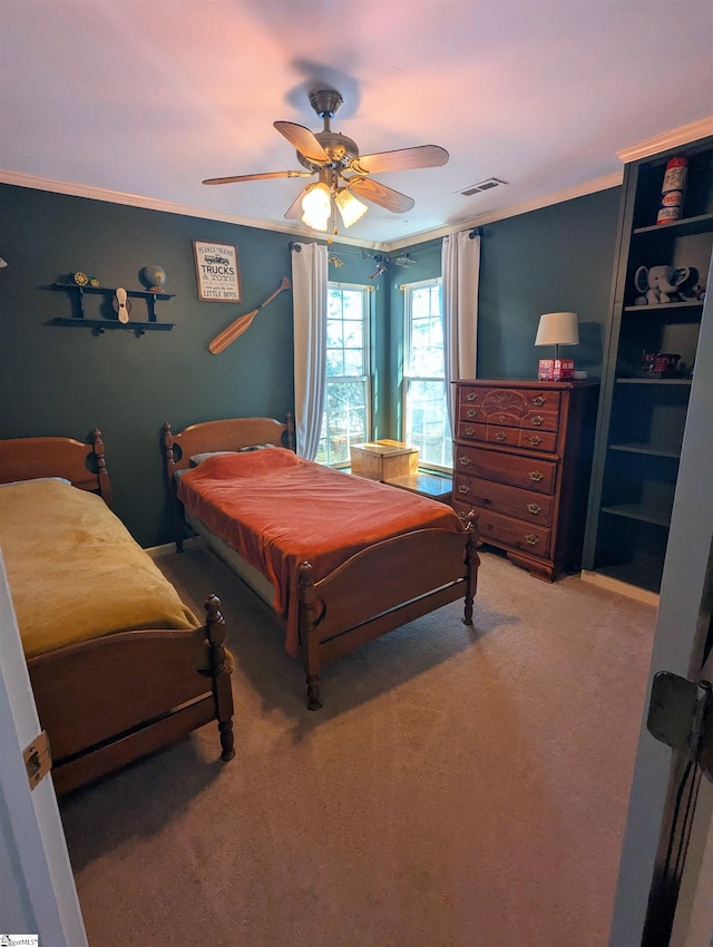 carpeted bedroom featuring a ceiling fan and ornamental molding