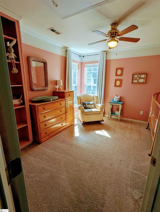 carpeted bedroom featuring ornamental molding, ceiling fan, and baseboards
