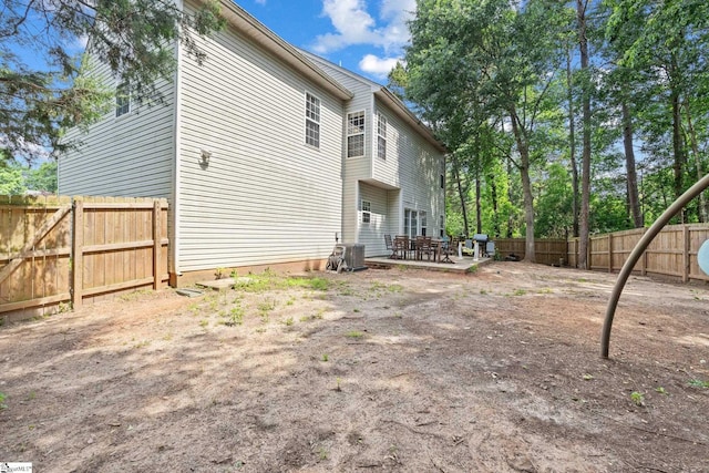 135 Bathurst Ln, Simpsonville, SC 29681 - rear view of property featuring a fenced backyard, a patio, central AC unit, and outdoor dining area