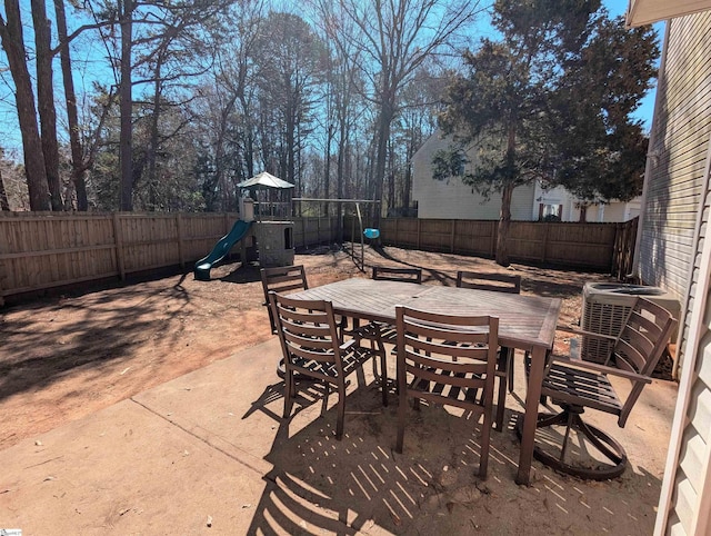 view of patio / terrace featuring outdoor dining area, a fenced backyard, cooling unit, and a playground
