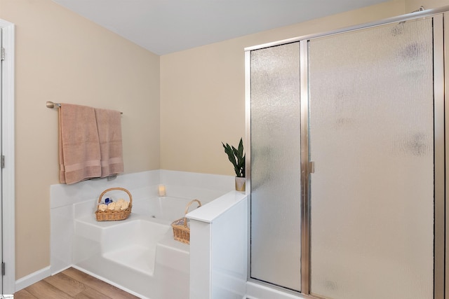 26 Willow Oak Ct, Simpsonville, SC 29681 - bathroom with wood finished floors, a bath, a stall shower, and baseboards