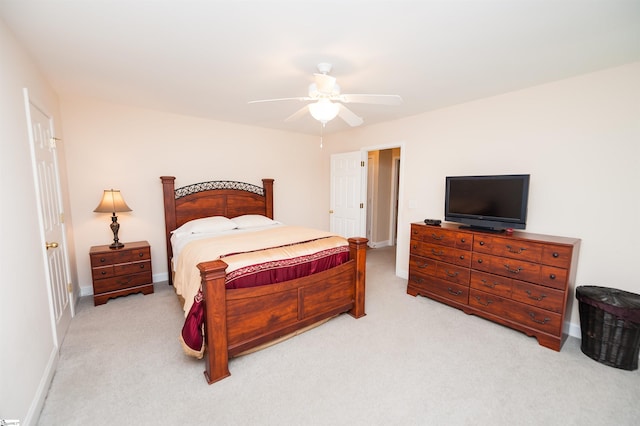 carpeted bedroom with baseboards and a ceiling fan