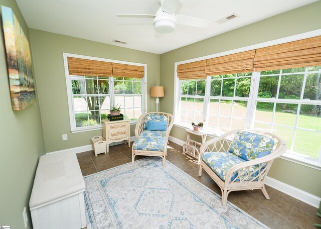 sitting room featuring a ceiling fan, tile patterned flooring, and baseboards
