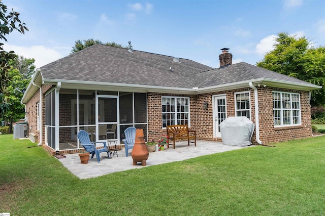 back of property featuring brick siding, a patio, and a shingled roof