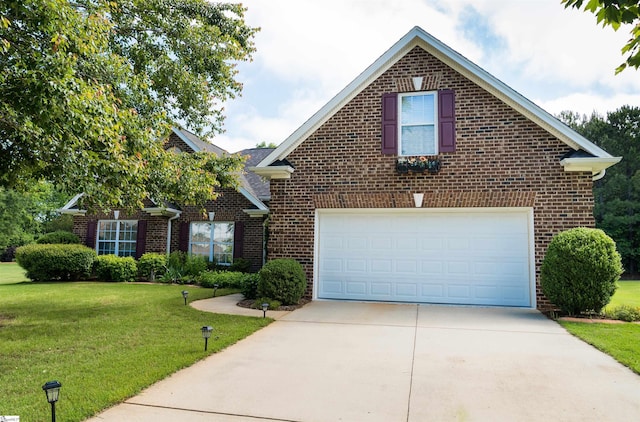 traditional home featuring brick siding, concrete driveway, and a front yard