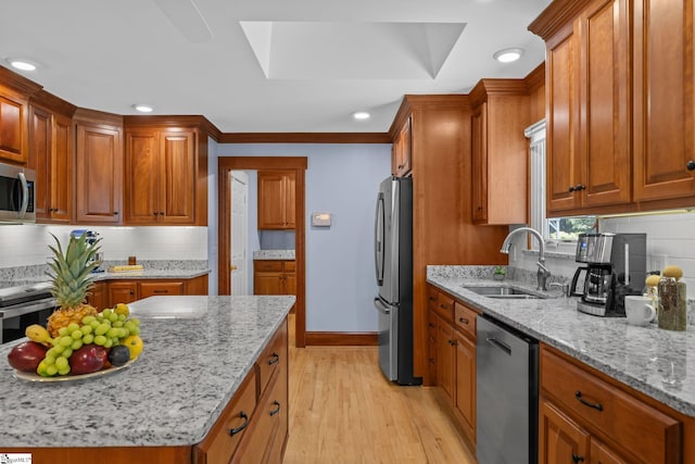 155 Mountain Lake Dr, Piedmont, SC 29673 - kitchen featuring stainless steel appliances, a sink, light wood finished floors, tasteful backsplash, and light stone counters