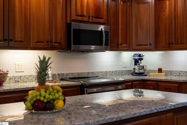 155 Mountain Lake Dr, Piedmont, SC 29673 - kitchen with appliances with stainless steel finishes, light stone counters, and backsplash