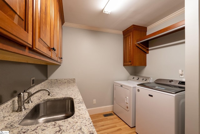 155 Mountain Lake Dr, Piedmont, SC 29673 - clothes washing area featuring washing machine and dryer, ornamental molding, cabinet space, light wood finished floors, and baseboards