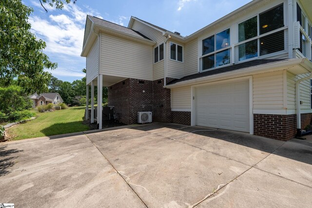 155 Mountain Lake Dr, Piedmont, SC 29673 - back of house featuring an attached garage, driveway, brick siding, a cooling unit, and a lawn
