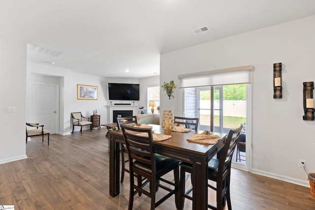 51 Oak Edge Ln, Greer, SC 29651 - dining area featuring dark wood-style flooring, a glass covered fireplace, and baseboards
