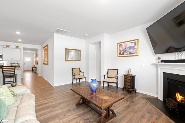 51 Oak Edge Ln, Greer, SC 29651 - living area featuring wood finished floors, a warm lit fireplace, baseboards, and recessed lighting