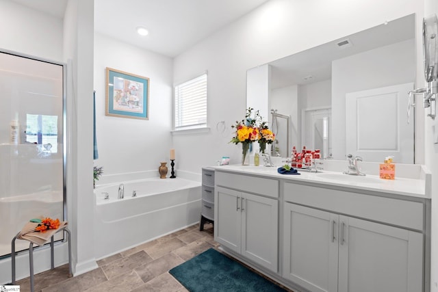 51 Oak Edge Ln, Greer, SC 29651 - full bathroom featuring a stall shower, a garden tub, vanity, and stone finish floors