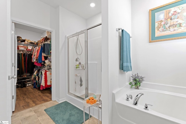 51 Oak Edge Ln, Greer, SC 29651 - full bathroom featuring a stall shower, a bath, a walk in closet, and recessed lighting