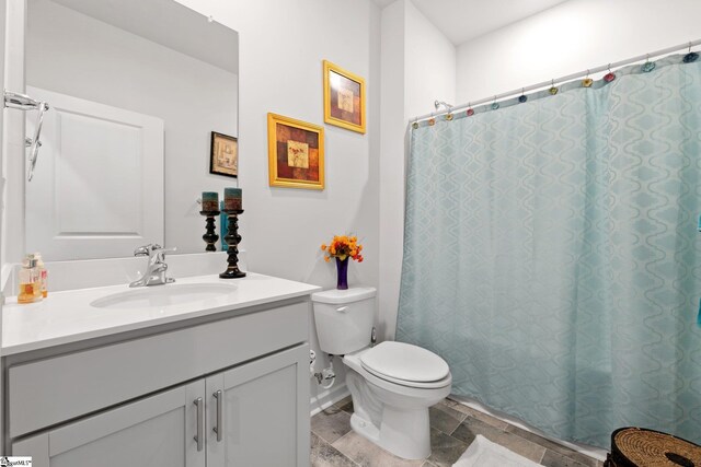 51 Oak Edge Ln, Greer, SC 29651 - full bath featuring vanity, toilet, stone finish flooring, and curtained shower