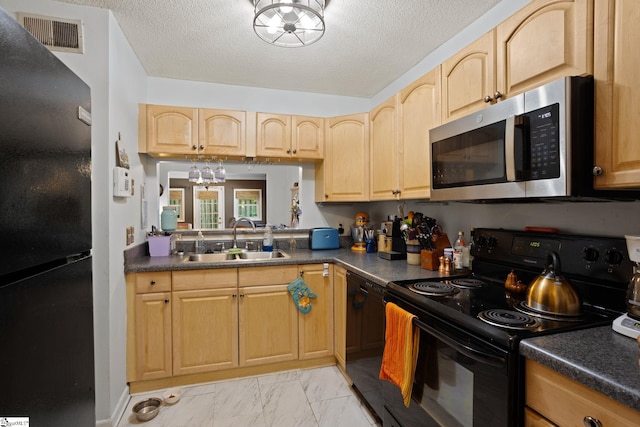 kitchen featuring black appliances, a sink, light marble finish flooring, light brown cabinets, and a textured ceiling