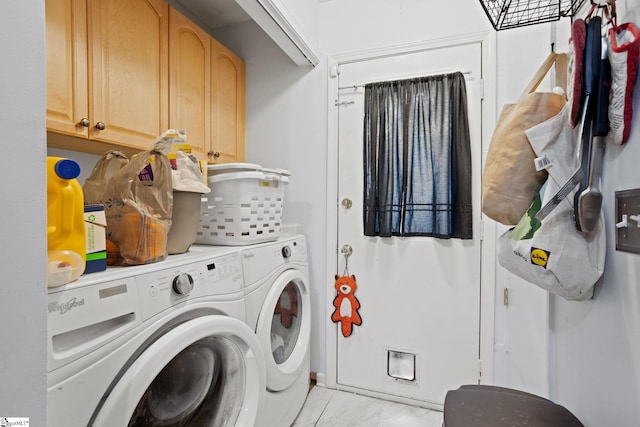washroom with washer and dryer, cabinet space, and light marble finish flooring