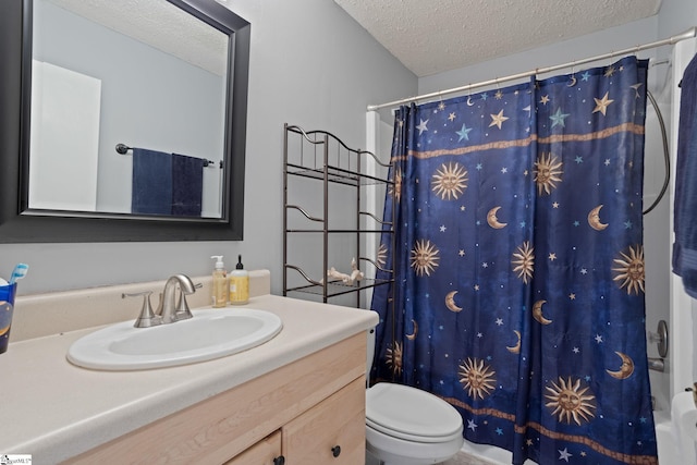 full bathroom featuring a textured ceiling, vanity, and toilet