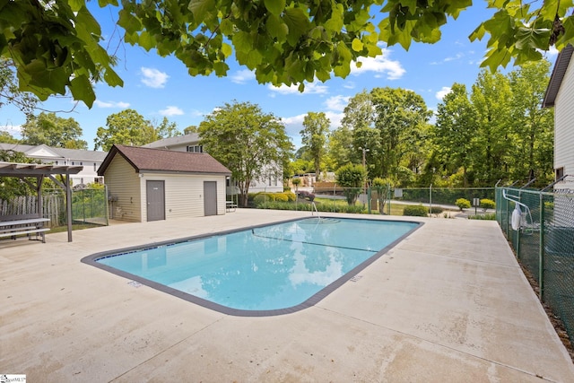 community pool featuring a patio and fence