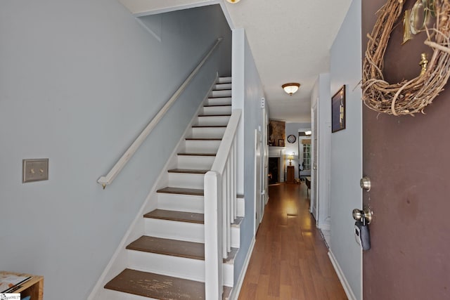 staircase featuring wood finished floors