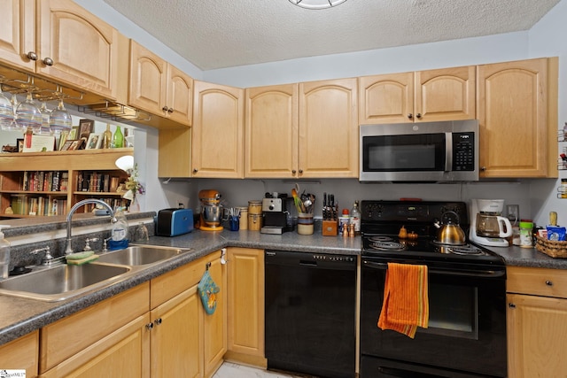 kitchen with black appliances, a sink, light brown cabinets, dark countertops, and a textured ceiling