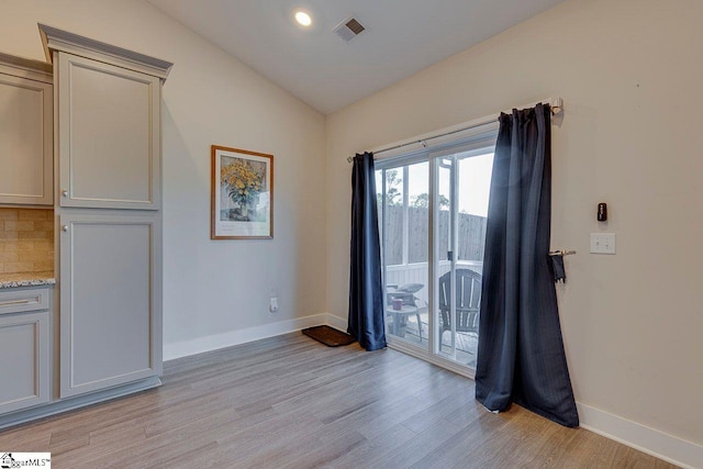 empty room with light wood-style flooring, lofted ceiling, baseboards, and recessed lighting