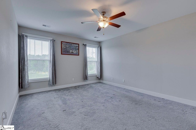 unfurnished room featuring ceiling fan, baseboards, and carpet