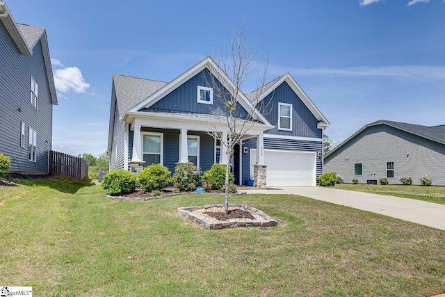 craftsman-style house with a garage, driveway, a front yard, board and batten siding, and covered porch