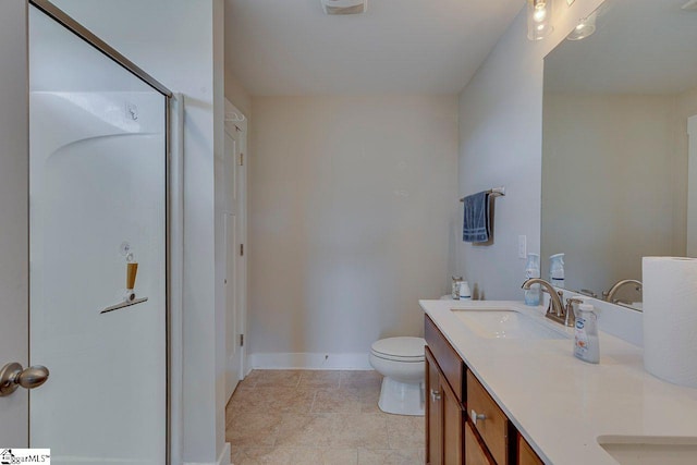 full bathroom featuring a stall shower, baseboards, double vanity, and toilet