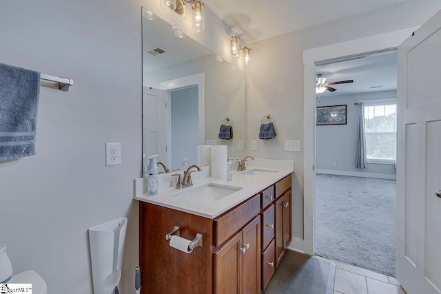 full bath featuring ceiling fan, double vanity, toilet, tile patterned flooring, and baseboards