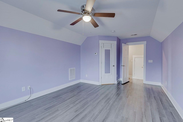 bonus room with lofted ceiling, ceiling fan, wood finished floors, and baseboards