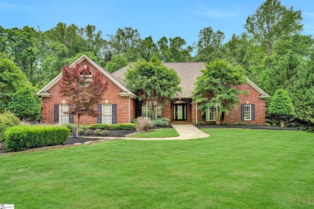 view of front of house with brick siding and a front lawn