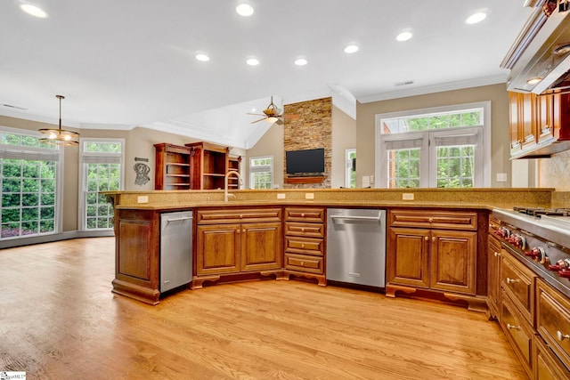 kitchen with appliances with stainless steel finishes, ornamental molding, light wood finished floors, healthy amount of natural light, and recessed lighting