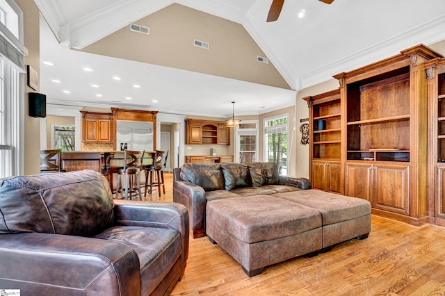 living area with a ceiling fan, light wood-style flooring, lofted ceiling, recessed lighting, and crown molding