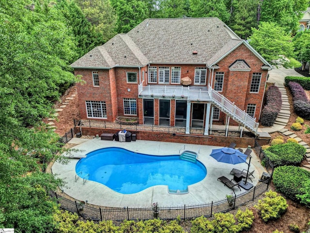 view of pool featuring stairs, a patio area, and a fenced backyard