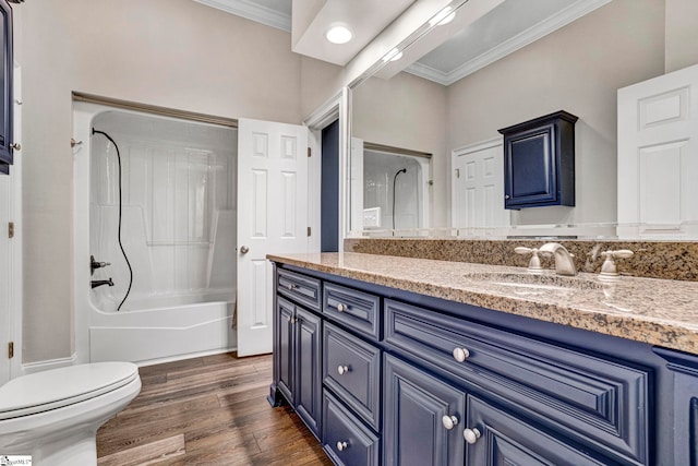 full bathroom with crown molding, wood finished floors, vanity, toilet, and bathing tub / shower combination