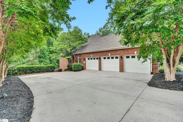 garage featuring concrete driveway